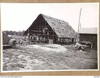 PORT MORESBY, NEW GUINEA. 1943-12-19. PHOTOGRAPHIC DARKROOM BEING BUILT FOR THE AUSTRALIAN MILITARY HISTORY SECTION BY TROOPS OF THE 101ST AUSTRALIAN ARMY TROOPS COMPANY AND ELECTRICIANS OF THE 9TH ..