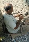 Elders and men making craft objects.