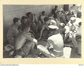 AT SEA. 1944-10-22. OFFICERS OF HEADQUARTERS FIRST ARMY ABOARD THE SS TAROONA PLAYING PONTOON ON THE BOAT DECK DURING THEIR MOVEMENT TO NEW GUINEA. CARDS, THE MOST POPULAR PASTIME DURING THE ..