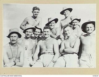 PORT MORESBY, PAPUA. 1942-07. SUN-TANNED AUSTRALIAN GUNNERS WHO HAVE SEEN SERVICE IN THE MIDDLE EAST, PICTURED IN A HAPPY GROUP IN NEW GUINEA