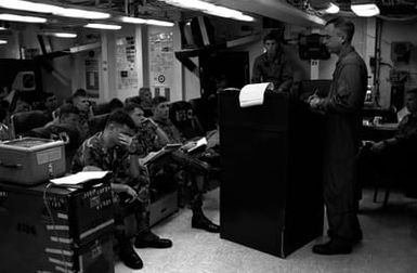 Marine Medium Helicopter Squadron 261 (HMM-261) officers receive a pre-operation briefing in the squadron ready room aboard the amphibious assault ship USS SAIPAN (LHA 2). The SAIPAN is on station off the coast of Liberia for Operation Sharp Edge