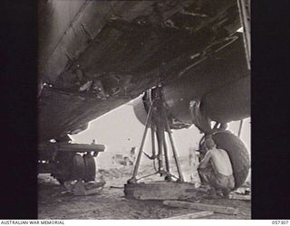 SOPUTA, NEW GUINEA. 1943-09-29. THE UNDERSIDE OF THE FUSELAGE OF THE MITCHELL BOMBER IN WHICH BRIGADIER R. B. SUTHERLAND WAS KILLED, SHOWING DAMAGE TO BOMB BAY DOORS AND FUSELAGE