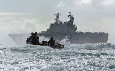 A US Marine Corps (USMC) AAV7A1 Amphibious Assault Vehicle assigned to the 3rd Amphibious Assault Battalion maneuvers through the waters of the Pacific Ocean, after exiting the well deck of the US Navy (USN) Tarawa Class Amphibious Assault Ship, USS PELEIU (LHA 5), heading toward the beach at Training Area Bellows, Hawaii (HI), to conduct infantry and amphibious training. (SUBSTANDARD)