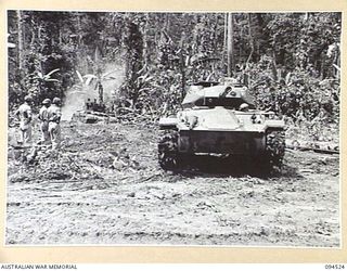 TOROKINA, BOUGAINVILLE, 1945-08-02. A MATILDA TANK BEING PULLED FROM A BOG BY M24 GENERAL CHAFFEE LIGHT TANKS. THE MATILDA BECAME BOGGED DURING TRIALS OF THE M24 CONDUCTED FOR THE WAR OFFICE