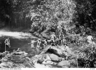 OWEN STANLEY RANGES, NEW GUINEA. C. 1942-09-01. AN INDICATION OF THE PRIMITIVE LINES OF COMMUNICATION AND OF THE DIFFICULTIES ENCOUNTERED IN THE MOVEMENTS OF TROOPS IS SHOWN HERE. NATIVE PORTERS ..