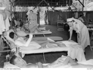 MILNE BAY, PAPUA. C. 1944-02. RAAF NURSING SISTERS YOUNG (LEFT) AND PERGER OF NO. 2 MEDICAL CLEARING STATION RAAF AT WORK IN THE WARD