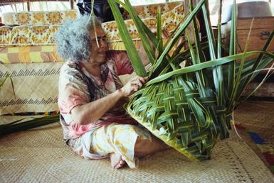 Woman weaving basket, Tokelau