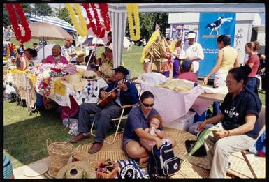 Family gathering at a Niuean stall at the Pasifika Festival, Western Springs