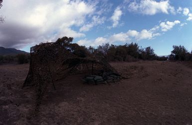 Camouflage netting hides the enterance to the Tactical Operation Center of the 2nd Brigade, 25th Infantry Division, located at the Pohakuloa Training Area and in use during Operation THUNDERBOLT