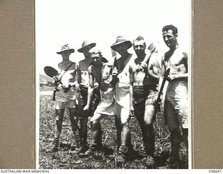 DUMPU, NEW GUINEA, 1943-10-05. TROOPS OF THE NO. 17 PLATOON, "D" COMPANY, 2/16TH AUSTRALIAN INFANTRY BATTALION, DRESSED IN NATIVE SARONGS FOUND IN DUMPU VILLAGE, AFTER THE JAPANESE HAD FLED. THESE ..