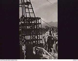 MILNE BAY, NEW GUINEA, 1943-07-11. LARGE PILEDRIVER IMPROVISED BY TROOPS OF THE 4TH AUSTRALIAN FIELD COMPANY, ROYAL AUSTRALIAN ENGINEERS, FOR THE CONSTRUCTION OF THE NEW 960 FEET "T" JETTY. ANCHORS ..