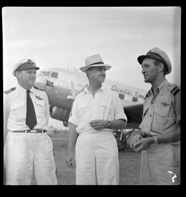 Qantas Empire Airways' personnel, from left to right, Captain W Forgan-Smith, Mr B Heath, veteran pilot, and First Officer W Purkiss, Papua New Guinea