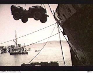 NEW GUINEA. 1943-07-24. UNLOADING A JEEP FROM THE M.V. "DUNTROON" DOCKED IN THE HARBOUR