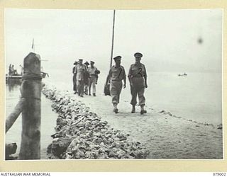 MALMAL VILLAGE, NEW BRITAIN. 1945-02-09. VISITING AUSTRALIAN GENERALS WITH THE GENERAL OFFICER COMMANDING, 5TH DIVISION WALKING UP THE VILLAGE JETTY ON THEIR WAY TO THE UNIT HEADQUARTERS. ..