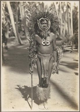 Types from Buna District [full length photo of man in head dress] Frank Hurley