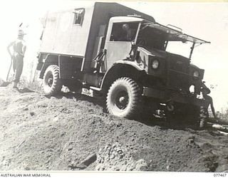 BABIANG ROAD, AITAPE, NEW GUINEA. 1944-12-04. AN AUSTRALIAN ARMY AMBULANCE CAREFULLY NEGOTIATING THE LOOSE SOIL ON THE EASTERN APPROACHES OF THE NEW BRIDGE ACROSS THE DRINIUMOR RIVER BUILT BY ..