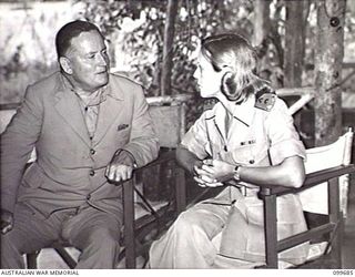 LAE, NEW GUINEA, 1946-01-28. SISTER D. J. DEALL CHATTING WITH THE HONOURABLE F. M. FORDE, MINISTER FOR THE ARMY, IN THE SISTERS' MESS AT 102 CASUALTY CLEARING STATION. MR FORDE IS ON AN INSPECTION ..