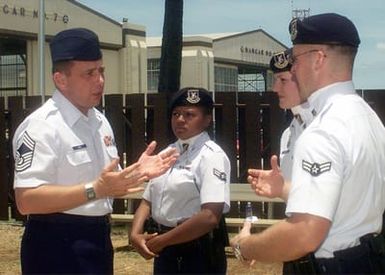 Right side front view medium shot as CHIEF MASTER Sergeant of the Air Force, Fredrick J. (Jim) Finch talks with three Security Police Officers from the 15th Security Forces, Hickam Air Force Base, Hawaii, during a visit on July 18th, 2000