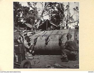 DALLMAN, WEWAK AREA, NEW GUINEA. 1945-08-28. CRAFTSMAN R.F. THOMPSON (1) AND CRAFTSMAN D. SIMKINS (2), MEMBERS OF LIGHT AID DETACHMENT ATTACHED 2/1 TANK ATTACK REGIMENT ROYAL AUSTRALIAN ARTILLERY, ..