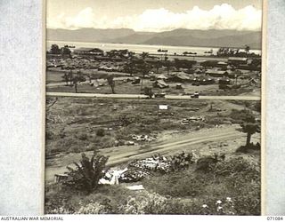 LAE, NEW GUINEA. 1944-03-10. AN AERIAL PHOTOGRAPH OF THE LAE BASE SUB-AREA SHOWING THE NEW ROAD AND A WRECKED BUILDING IN THE FOREGROUND