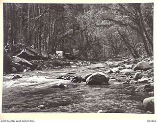 BARGES HILL, CENTRAL BOUGAINVILLE. 1945-06-27. THE VIEW LOOKING UP THE DOIABI RIVER TOWARDS THE CAMP SITE OF 8 FIELD AMBULANCE ADVANCED DRESSING STATION ON THE NUMA NUMA TRAIL