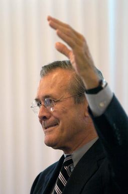 The Honorable Donald H. Rumsfeld, U.S. Secretary of Defense, answers a question from the audience at a town hall meeting in the Magellan Hall Dining Facility at Andersen Air Force Base, Guam on Nov. 14, 2003. (DoD photo by TECH. SGT. Andy Dunaway) (Released)