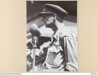 LAE, NEW GUINEA, 1945-12-01. G.H.S. MORAN ADDRESSING TROOPS OF LAE BASE SUB AREA WORKSHOP, CORPS OF AUSTRALIAN ELECTRICAL AND MECHANICAL ENGINEERS, DURING A PARADE HELD ON THE OCCASION OF THE THIRD ..