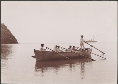 The Reverend C.C. Godden and crew in a boat at Lolowai Bay, Opa, New Hebrides, 1906 / J.W. Beattie