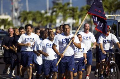 U.S. Navy CHIEF PETTY Officer selectees run in formation during the initial phase of CPO training at Naval Station Pearl Harbor, Hawaii, on Aug. 18, 2006. The newly selected Sailors will endure six weeks of arduous physical fitness and team building exercises as they transition to become Navy Chiefs. (U.S. Navy photo by Mass Communication SPECIALIST 1ST Class Dennis C. Cantrell) (Released)