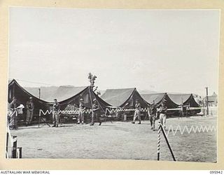 WEWAK POINT, NEW GUINEA. 1945-08-31. THE HEADQUARTERS COMPANY, 2/3 MACHINE-GUN BATTALION PARADE GROUND AND TENT LINES