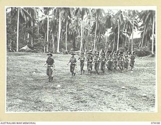 SIAR, NEW GUINEA. 1944-06-22. PERSONNEL OF NO.13 PLATOON, C COMPANY, 57/60TH INFANTRY BATTALION MOVING OFF THE UNIT PARADE GROUND AT THE CONCLUSION OF THE MORNING PARADE. IDENTIFIED PERSONNEL ARE:- ..