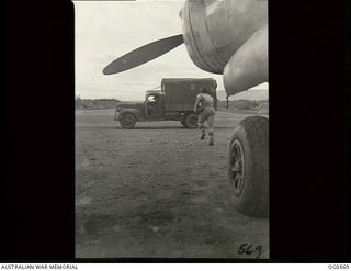 MILNE BAY, PAPUA. 1943-07-31. LEADING AIRCRAFTMAN E. GRIFFITHS OF CAULFIELD, VIC, RUNNING FROM A P38 LOCKHEED LIGHTNING PHOTOGRAPHIC RECONNAISSANCE AIRCRAFT ATTACHED TO NO. 75 (FIGHTER) SQUADRON ..