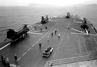 Elevated view of four CH-46 Sea Knight helicopters parked on the deck of the amphibious assault ship USS SAIPAN during the NATO exercise Display Determination '81 that took place September 19 to October 14, 1981