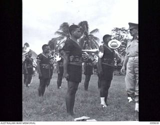 LAE, NEW GUINEA, 1946-02-14. MAJOR GENERAL B.M. MORRIS, GENERAL OFFICER COMMANDING, AUSTRALIAN NEW GUINEA ADMINISTRATIVE UNIT, INSPECTING MEMBERS OF THE BAND OF THE ROYAL PAPUAN CONSTABULARY DURING ..