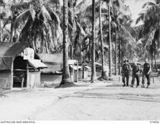 ALEXISHAFEN, NEW GUINEA. 1944-09-14. THE AMENITIES HUT, THE SERGEANTS' MESS REGIMENTAL AID POST AND SHOWERS IN THE CAMP AREA OF THE 133RD BRIGADE ORDNANCE FIELD PARK. IDENTIFIED PERSONNEL ARE:- ..