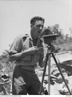 LAE, NEW GUINEA. 1943-10-11. SERGEANT D. MCKECKNIE, NEWS-REEL CAMERAMAN OF AUSTRALIAN MILITARY HISTORY SECTION, POSES FOR HIS PHOTOGRAPH