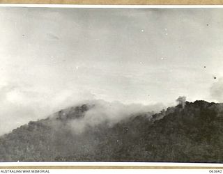 FARIA RIVER, NEW GUINEA. 1944-01-20. SMOKE RISING FROM JAPANESE POSITIONS ACROSS MAIN CREEK, AFTER A STRIKE BY ALLIED MITCHELL BOMBERS