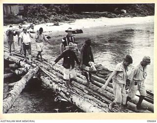 BONIS PENINSULA, BOUGAINVILLE. 1945-09-16. SERGEANT G.F. PALMER, ACCOMPANYING JAPANESE STRETCHER CASES BEING EVACUATED TO 17 FIELD AMBULANCE, SORAKEN, FOR MEDICAL TREATMENT. MEDICAL ATTENTION ..