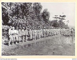 A LINE UP OF JAPANESE WOUNDED AND SICK ON NUMA NUMA BEACH FOR MEDICAL INSPECTION. MEMBERS OF THE AUSTRALIAN SURRENDER PARTY FROM HEADQUARTERS 2 CORPS HAVE ARRIVED AT NUMA NUMA PLANTATION TO DISCUSS ..