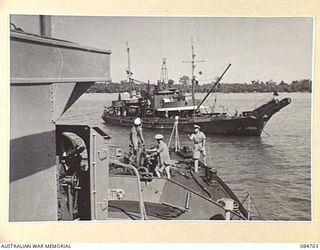 MIOS WUNDI, DUTCH NEW GUINEA. 1944-11-13. HMAS STAWELL IN HARBOUR MOVING PAST A USN CABLE LAYING SHIP