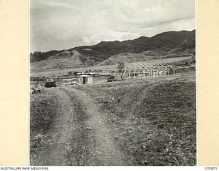 WAU, NEW GUINEA, 1944-02-23. THE FRAMEWORK OF THE FIRST OF ONE HUNDRED AND EIGHTY HUTS BEING BUILT BY THE 2/4TH FIELD SQUADRON AS A REST CAMP SITE. ON COMPLETION THE CAMP WILL ACCOMMODATE A BRIGADE