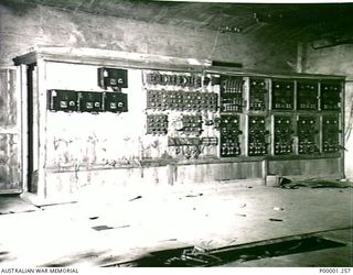 THE SOLOMON ISLANDS, 1945-10-11. A LARGE JAPANESE ELECTRICAL SWITCHBOARD INSIDE A CONCRETE BUILDING ON BOUGAINVILLE ISLAND. (RNZAF OFFICIAL PHOTOGRAPH.)