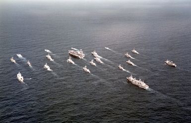 Twenty-one warships lead by NIMITZ Class Aircraft Carrier USS ABRAHAM LINCOLN (CVN 72) cruise in parade formation off the west coast of the island of Oahu, Hawaii. The ships are participants in RIMPAC 2000, the largest maritime exercise in the Asia-Pacific region, bringing together military forces from seven different nations. (Substandard image)