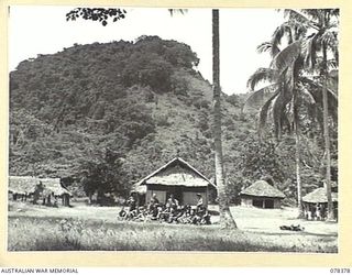 KALAMPUN VILLAGE, NEW BRITAIN. 1945-01-16. TROOPS OF "A" COMPANY, 14/32ND INFANTRY BATTALION RESTING IN THIS PICTURESQUE SETTING OF THE NATIVE VILLAGE AFTER THEIR MARCH FROM SAMPUN