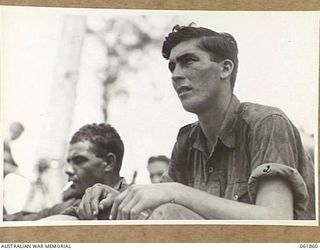 KOKODA TRAIL, NEW GUINEA. 1943-12-19. NX98280 PRIVATE J. RYAN (1) AND NX97588 PRIVATE C. C. SCOTT (2), BOTH OF THE 2/9TH AUSTRALIAN INFANTRY BATTALION, WHO WERE EXTRAS DURING THE FILMING OF ..