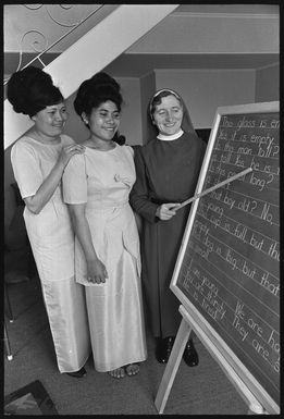 Sister Raphael at the blackboard with two of her English class, Mary Lomano (left) and Val Raphael