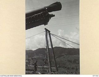 EVAPIA RIVER, NEW GUINEA, 1944-03-15. THE HUGE MAIN SUPPORT FOR THE SUSPENSION BRIDGE UNDER CONSTRUCTION OVER THE EVAPIA RIVER NEAR KESAWAI BEING HOISTED INTO POSITION BY ENGINEERS FROM THE 2/4TH ..