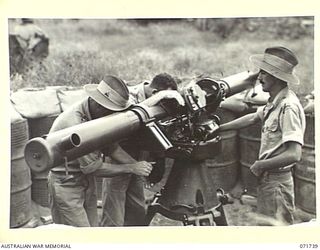 LAE, NEW GUINEA, 1944-03-26. MEMBERS OF C TROOP, PREDICTOR DETACHMENT, 2/6TH HEAVY ANTI-AIRCRAFT BATTERY OPERATING A BARR & STROUND HEIGHT AND RANGE FINDER NO. 3 MKIV AT THE 2/3RD ANTI-AIRCRAFT ..