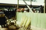 Stiff grass hand brooms and flowers for sale at Rabaul market, 1964