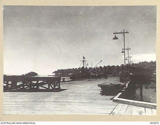 JACQUINOT AREA, NEW BRITAIN. 1945-06-09. THE WHARF, LOOKING ALONG THE WATERFRONT TOWARDS THE HEADQUARTERS 5 BASE SUB-AREA, INDICATING THE USE MADE OF THE AREA